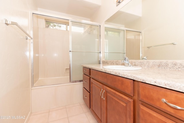 full bathroom featuring tile patterned floors, vanity, and bath / shower combo with glass door