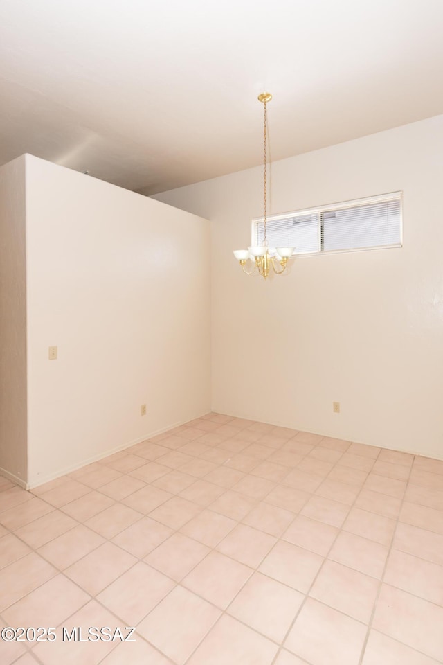 unfurnished room with a chandelier