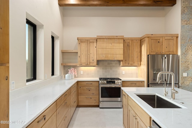 kitchen featuring decorative backsplash, appliances with stainless steel finishes, open shelves, a sink, and light brown cabinets