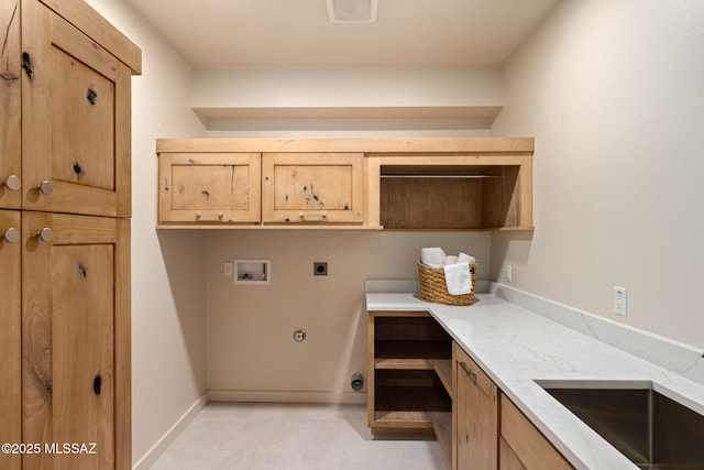 clothes washing area with cabinet space, washer hookup, a sink, hookup for an electric dryer, and visible vents