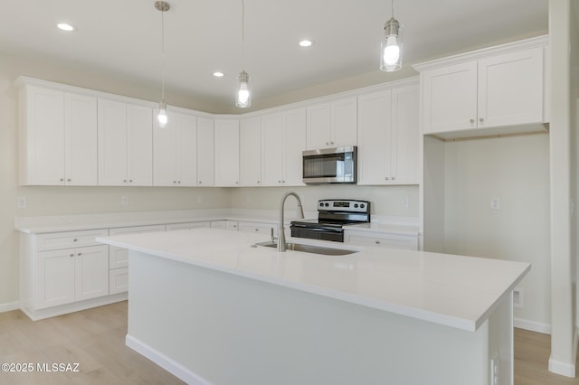 kitchen featuring white cabinetry, appliances with stainless steel finishes, light wood-style flooring, and recessed lighting