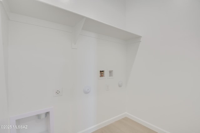 washroom featuring laundry area, baseboards, electric dryer hookup, washer hookup, and hookup for a gas dryer