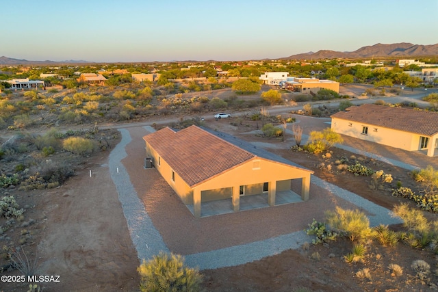 aerial view at dusk featuring a mountain view