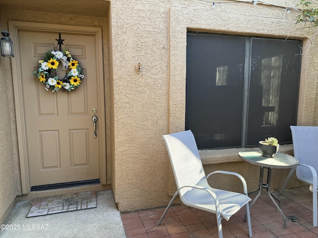 property entrance with stucco siding