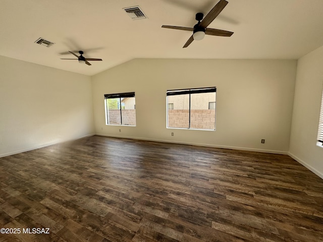 spare room featuring visible vents, dark wood finished floors, ceiling fan, and vaulted ceiling