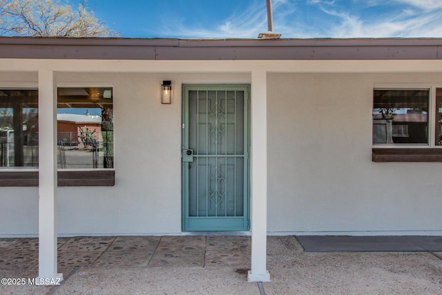 entrance to property with stucco siding