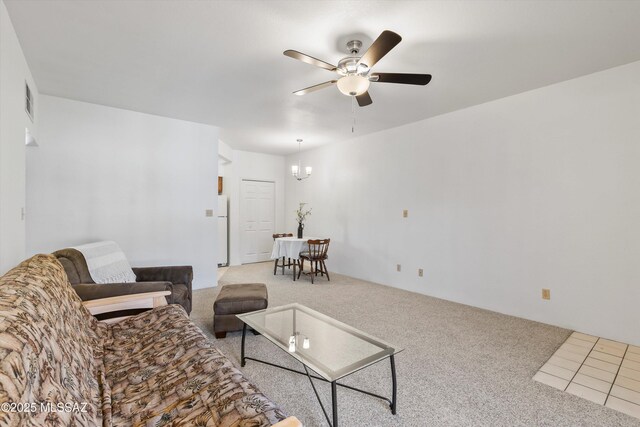 living room with ceiling fan, visible vents, and carpet floors