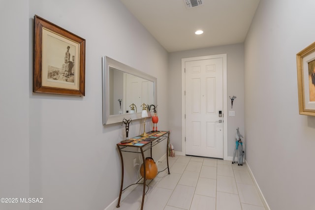 doorway to outside with recessed lighting, light tile patterned floors, visible vents, and baseboards
