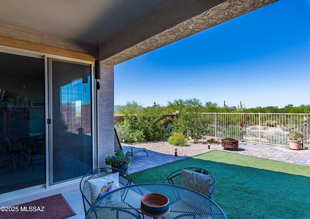 view of patio featuring a fenced backyard and an outdoor fire pit