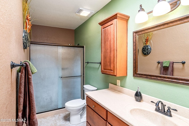 full bathroom featuring vanity, visible vents, toilet, and a shower stall