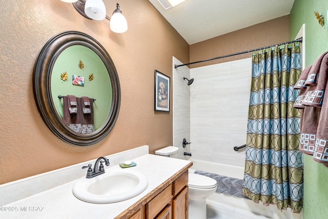 bathroom with toilet, shower / bathtub combination with curtain, a textured wall, and vanity