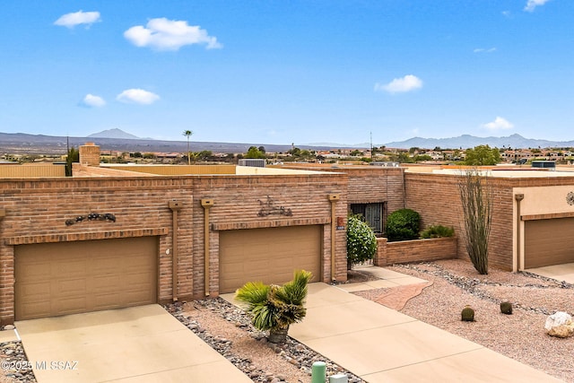 view of front of house featuring driveway and a mountain view