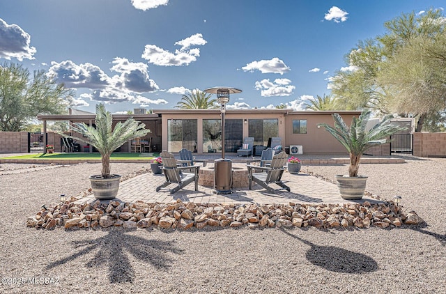 back of property with fence and a patio