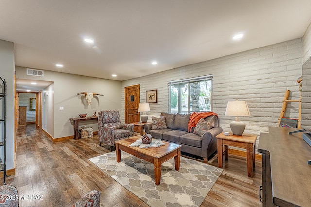 living room with visible vents, light wood-style floors, and recessed lighting