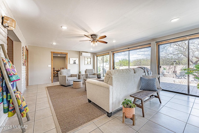 living area featuring light tile patterned flooring, a wall mounted AC, recessed lighting, and a ceiling fan
