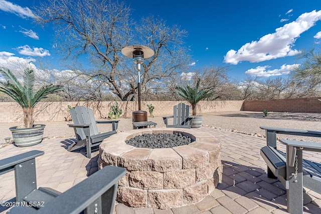 view of patio with an outdoor fire pit and a fenced backyard