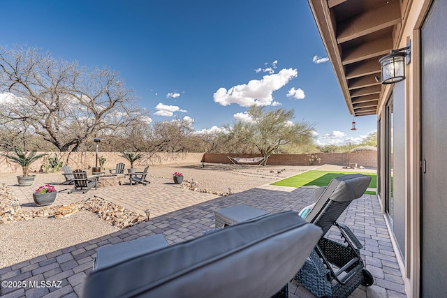 view of patio featuring a fire pit and a fenced backyard