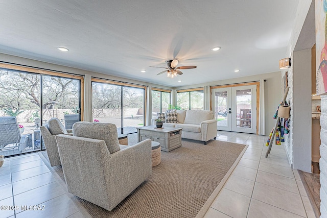 living area featuring french doors, a ceiling fan, light tile patterned flooring, and recessed lighting