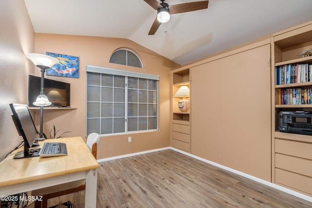 office featuring baseboards, a ceiling fan, wood finished floors, and lofted ceiling