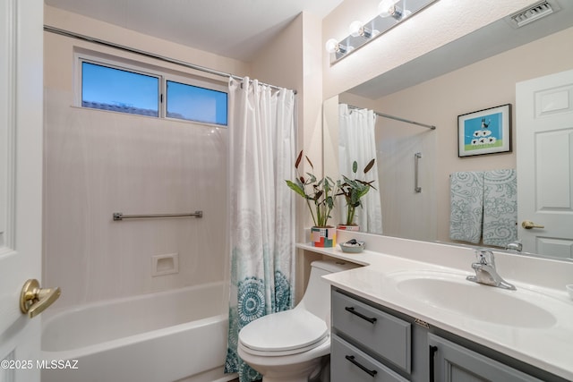 bathroom featuring vanity, visible vents, toilet, and shower / bath combo with shower curtain