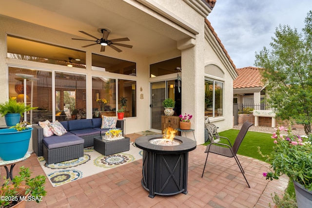 view of patio featuring an outdoor living space with a fire pit, a ceiling fan, and fence