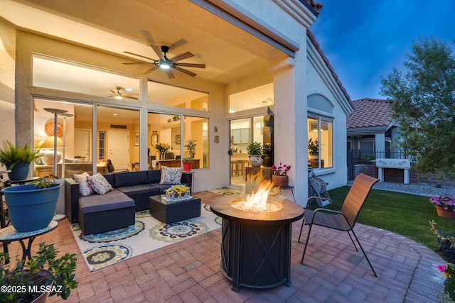 view of patio / terrace with an outdoor living space with a fire pit, fence, and a ceiling fan