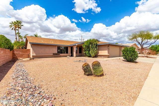 8691 N Huckelberry Way, Tucson, AZ 85742 - ranch-style house featuring concrete driveway, a garage, stucco siding, and fence