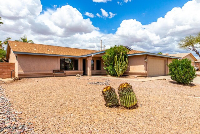 8691 N Huckelberry Way, Tucson, AZ 85742 - single story home with a garage, stucco siding, and concrete driveway