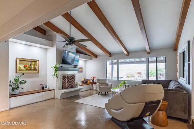 living area with a fireplace with raised hearth, a ceiling fan, and finished concrete floors