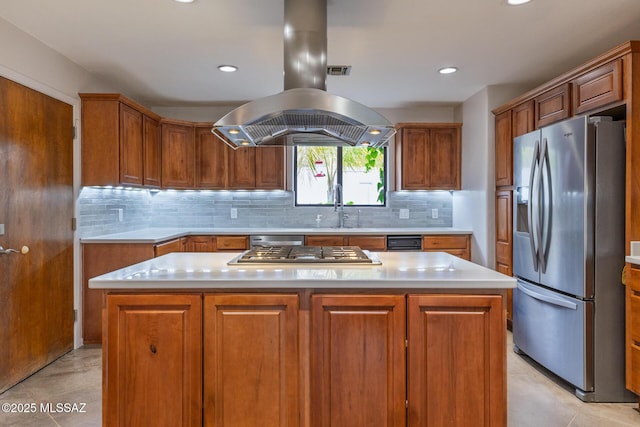 kitchen featuring appliances with stainless steel finishes, island exhaust hood, a sink, light countertops, and recessed lighting