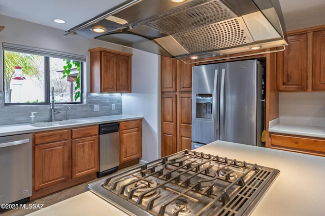 kitchen with stainless steel appliances, a sink, extractor fan, light countertops, and brown cabinets