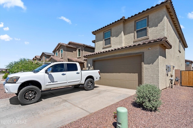 22082 E Thunderhead Dr, Red Rock, AZ 85145 - exterior space featuring concrete driveway, an attached garage, a tile roof, and stucco siding
