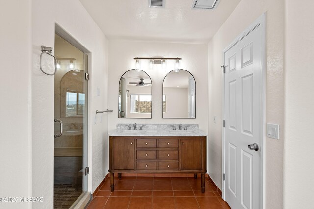 full bathroom with tile patterned floors, a sink, double vanity, and a stall shower