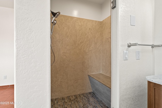 full bathroom featuring tile patterned flooring, vanity, and walk in shower