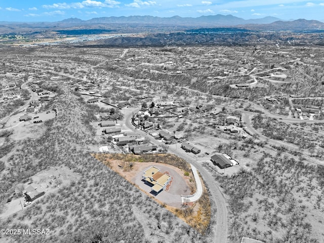 birds eye view of property with a mountain view