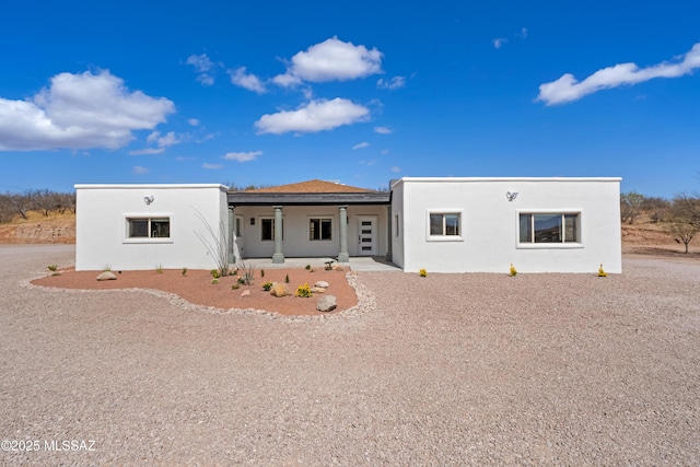 view of front of home featuring covered porch and stucco siding