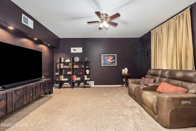 carpeted home theater with baseboards, a ceiling fan, and visible vents