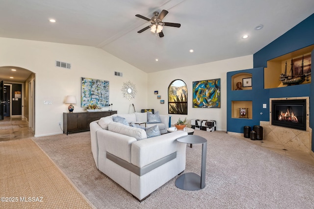 living room featuring ceiling fan, light colored carpet, lofted ceiling, and visible vents