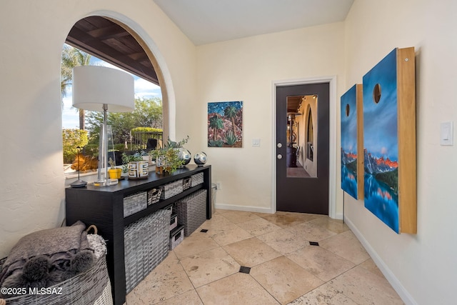 entrance foyer featuring arched walkways and baseboards