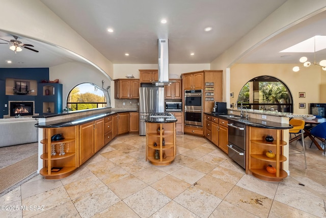 kitchen featuring open shelves, stainless steel appliances, and a peninsula