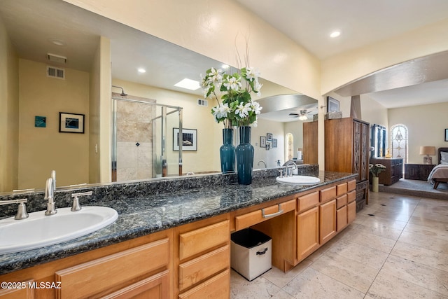 full bathroom with a sink, a ceiling fan, a stall shower, and visible vents