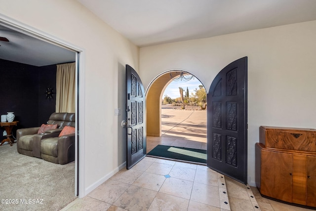 foyer with baseboards and light tile patterned floors