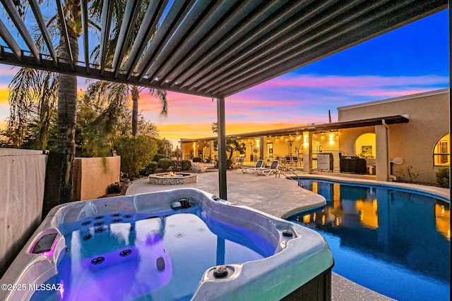 outdoor pool featuring fence, a hot tub, a fire pit, and a patio area