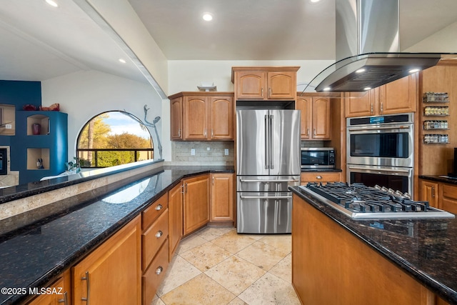 kitchen with decorative backsplash, stainless steel appliances, dark stone countertops, and island exhaust hood