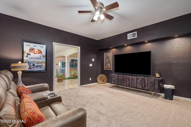 living room featuring carpet floors, ceiling fan, visible vents, and baseboards