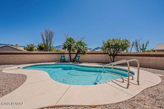 view of pool with a fenced backyard, a fenced in pool, and a patio