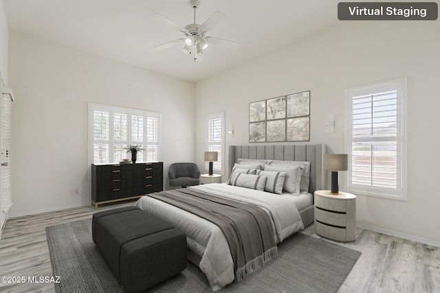 bedroom featuring baseboards, light wood-style floors, and ceiling fan