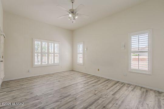 unfurnished room with ceiling fan and wood finished floors