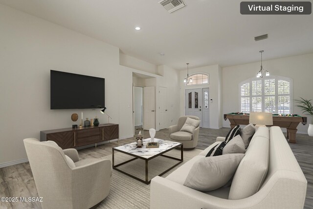 living area with light wood-style flooring, billiards, and visible vents
