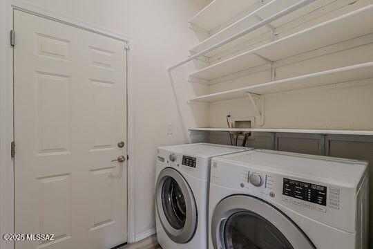 washroom with washing machine and dryer and laundry area